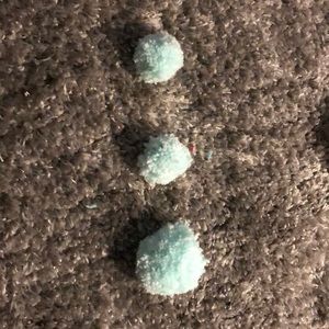 Three mint green pom-poms